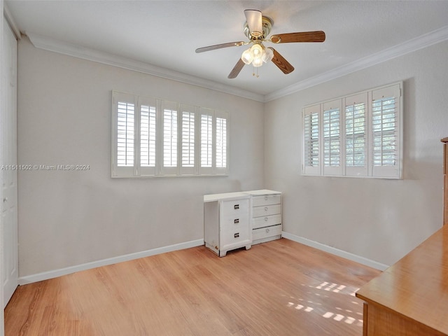 unfurnished room with a wealth of natural light, ornamental molding, light hardwood / wood-style floors, and ceiling fan