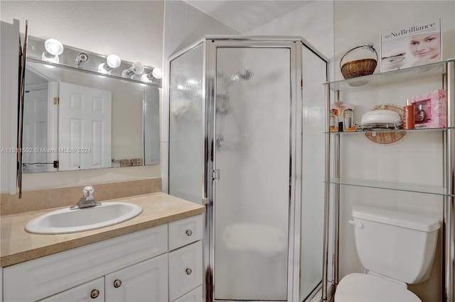 bathroom featuring walk in shower, oversized vanity, and toilet