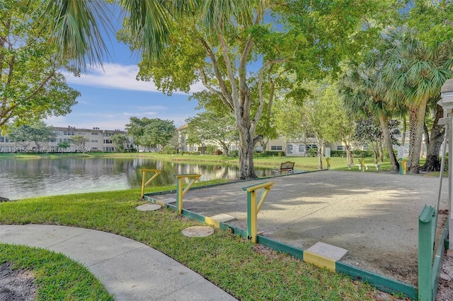 view of property's community with a yard and a water view