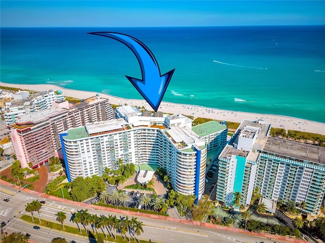 aerial view featuring a view of the beach and a water view