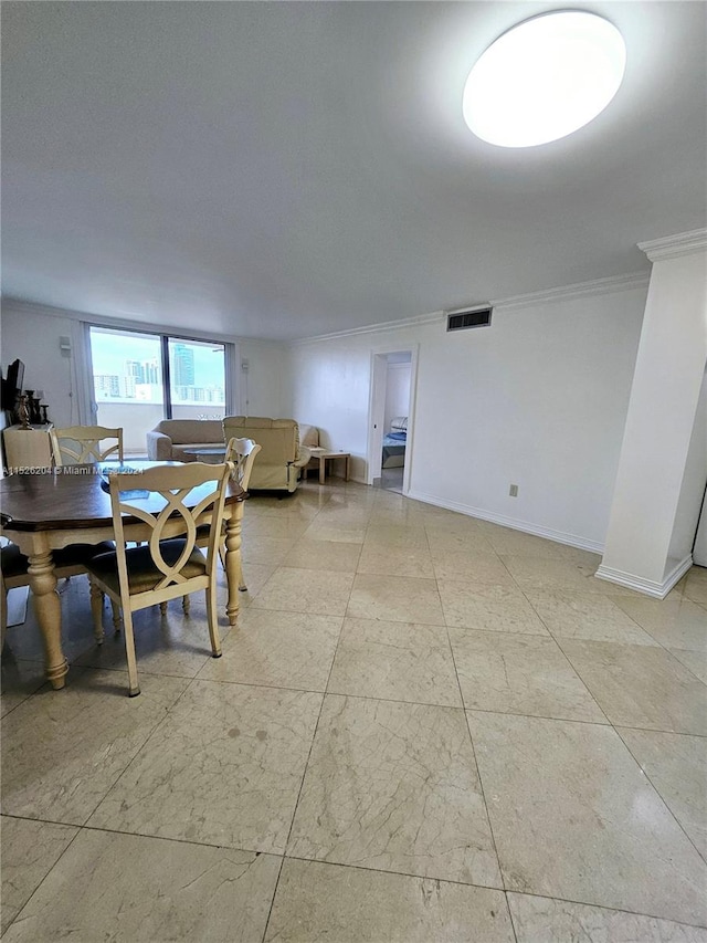 dining space featuring crown molding and light tile floors