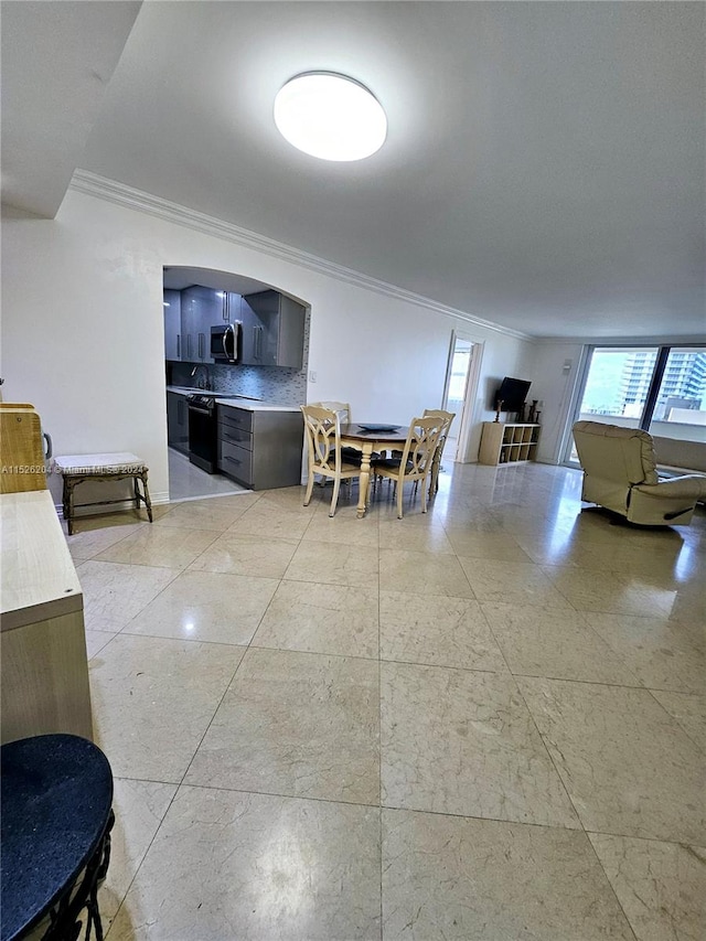 interior space with light tile floors and crown molding