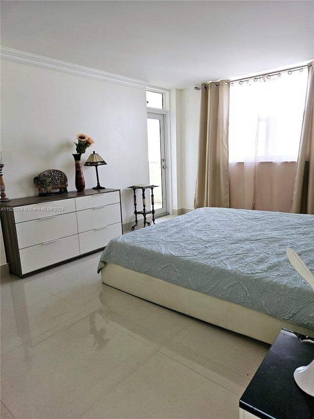 bedroom with ornamental molding and light tile floors