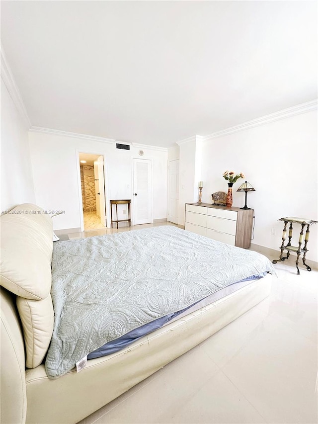 bedroom with ornamental molding and light tile floors