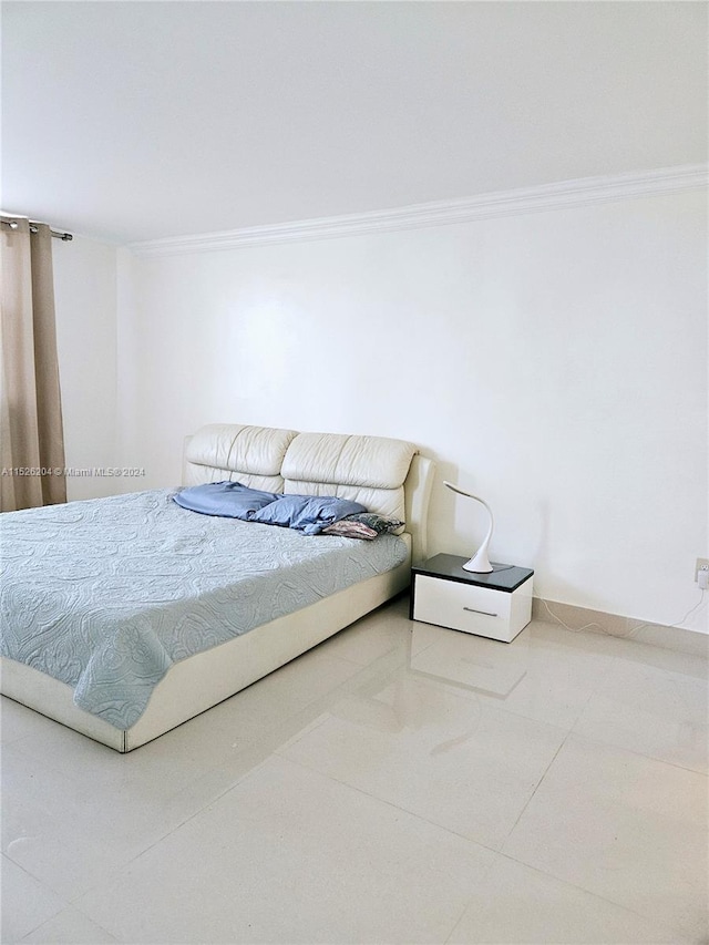 tiled bedroom featuring ornamental molding