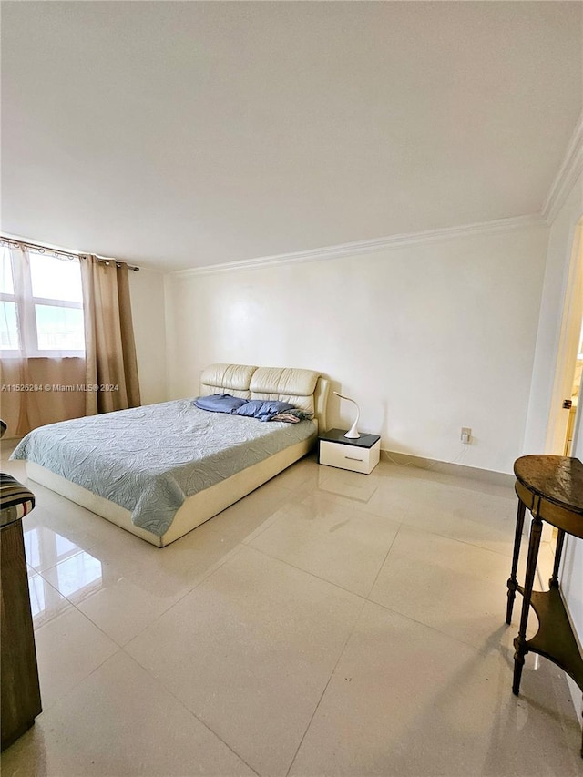 bedroom with ornamental molding and light tile floors