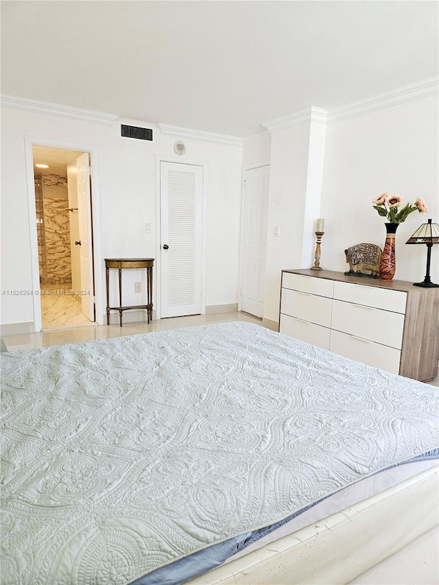 bedroom featuring ensuite bath and ornamental molding