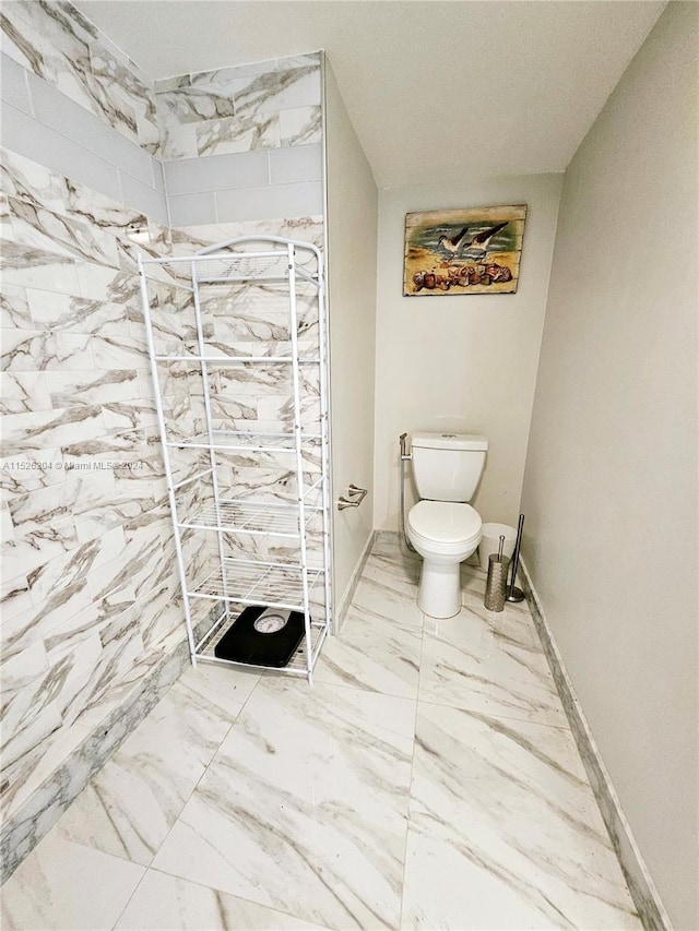 bathroom with tile floors and toilet