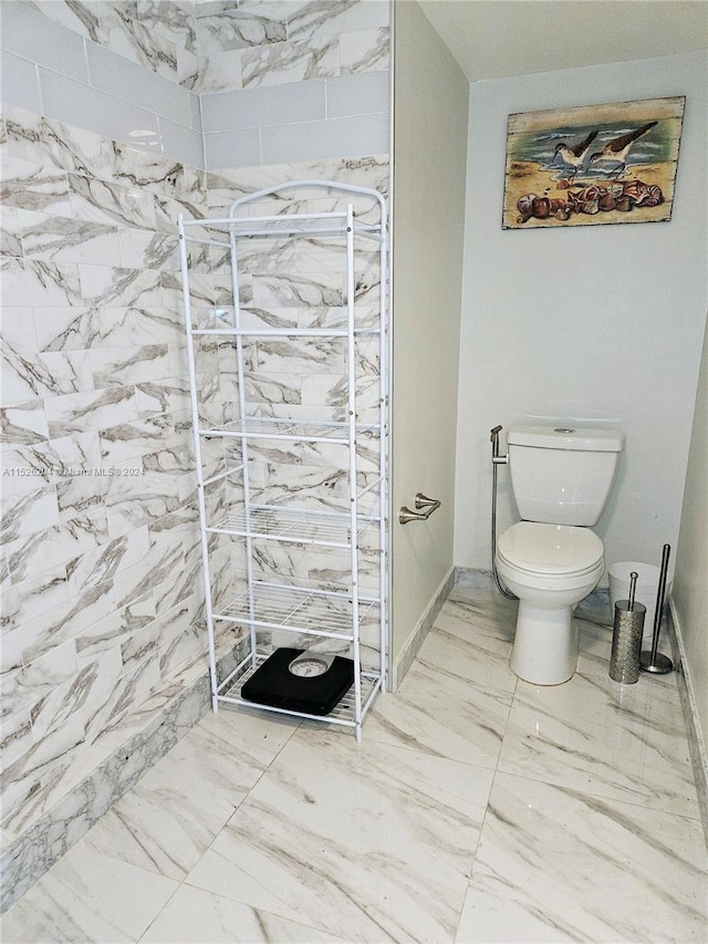 bathroom featuring toilet and tile flooring