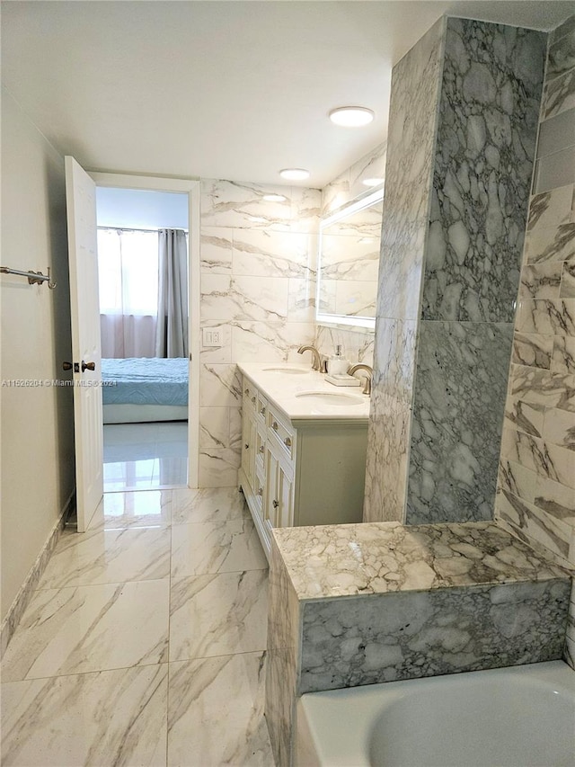 bathroom featuring a tub, tile walls, vanity, and tile flooring