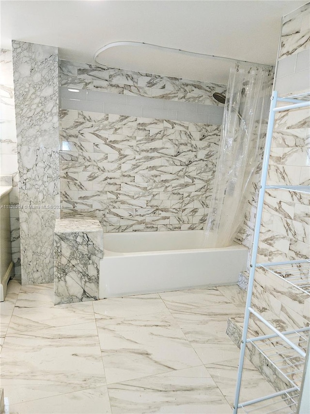 bathroom with tile flooring and tiled shower / bath