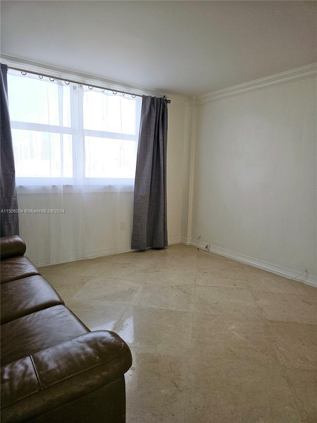 unfurnished living room with ornamental molding and light tile flooring