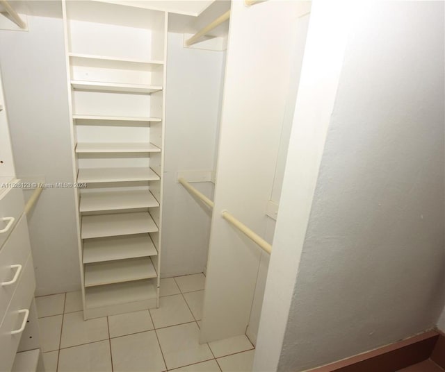 walk in closet featuring light tile floors