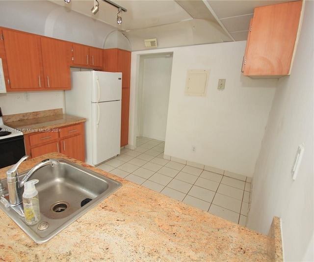 kitchen with light tile floors, white appliances, rail lighting, and sink