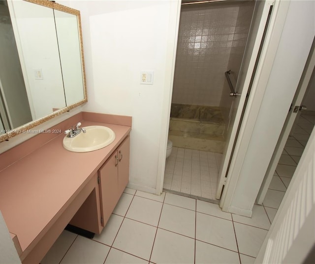 bathroom featuring toilet, tile flooring, and vanity