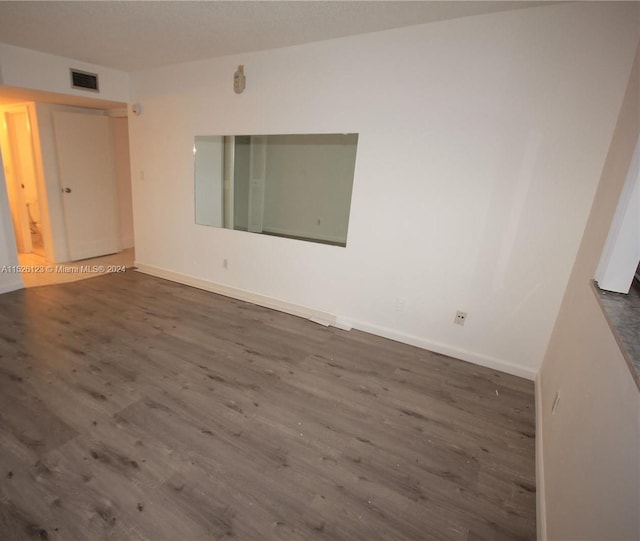 empty room featuring dark wood-type flooring