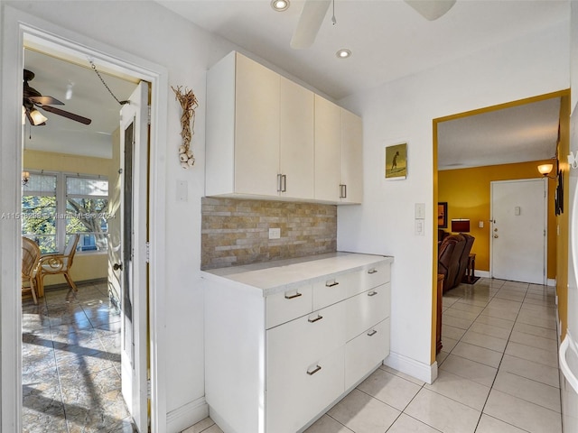 kitchen featuring white cabinetry, tasteful backsplash, ceiling fan, and light tile floors