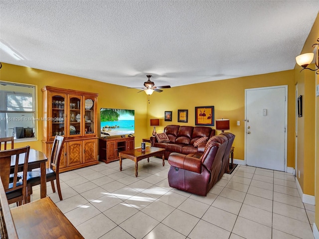 tiled living room with a textured ceiling and ceiling fan