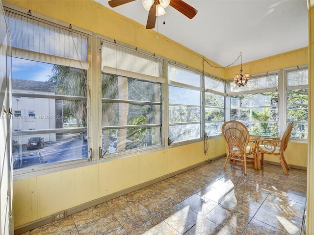 sunroom / solarium with ceiling fan with notable chandelier