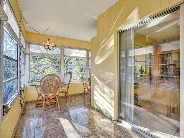 sunroom featuring an inviting chandelier