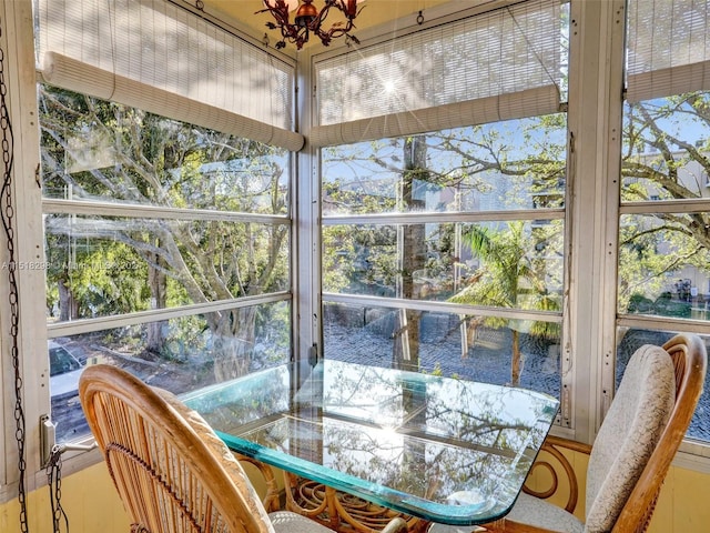 sunroom / solarium featuring a chandelier and a wealth of natural light