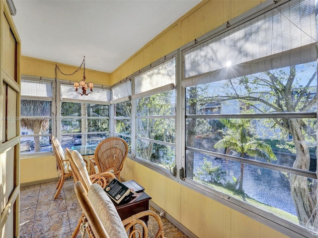 sunroom with a chandelier and a healthy amount of sunlight