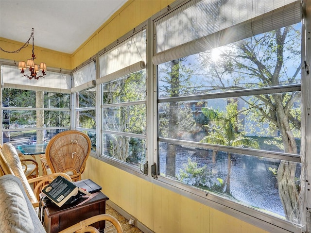 sunroom featuring a notable chandelier