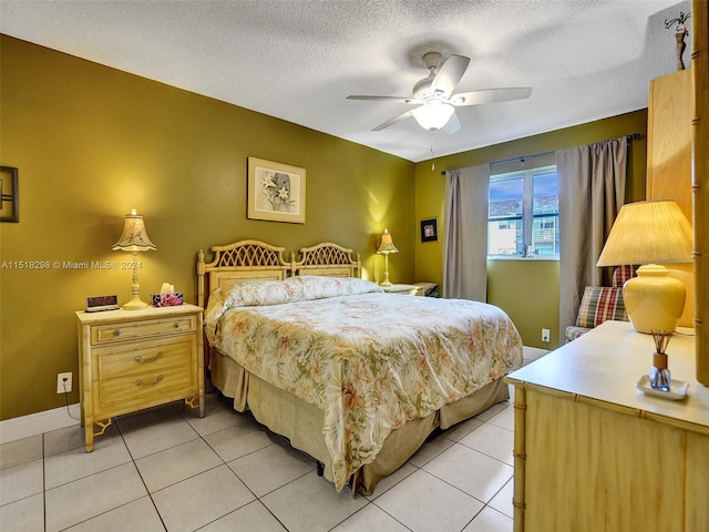 tiled bedroom featuring a textured ceiling and ceiling fan