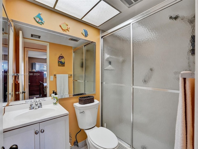 bathroom with walk in shower, toilet, and vanity