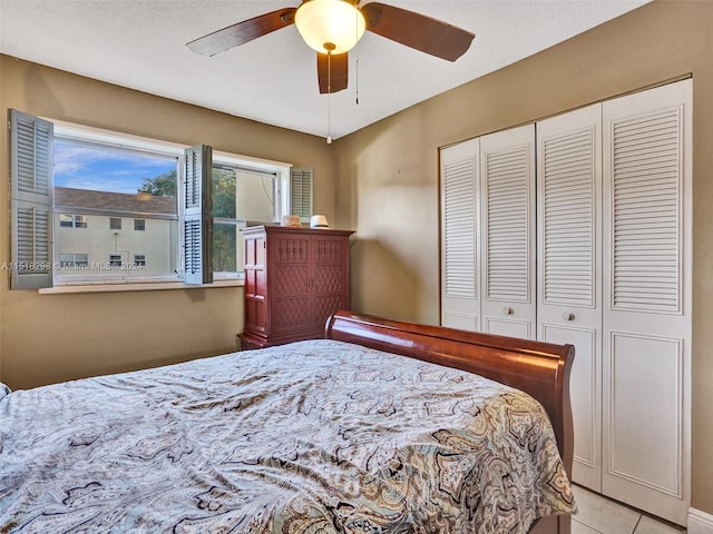 tiled bedroom featuring a closet and ceiling fan