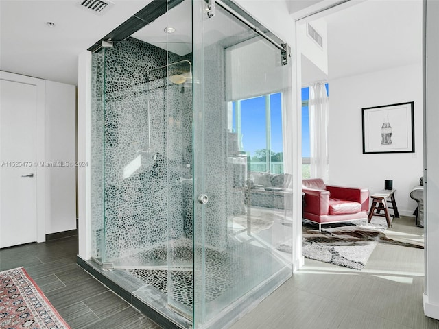 bathroom featuring a shower with shower door