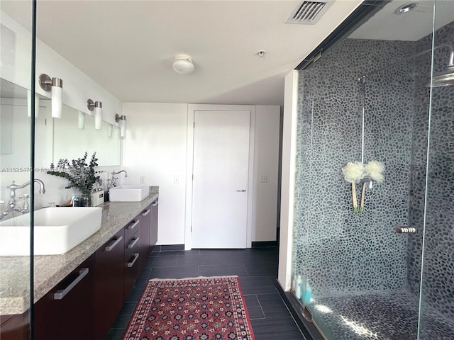 bathroom with tile patterned flooring, an enclosed shower, and vanity