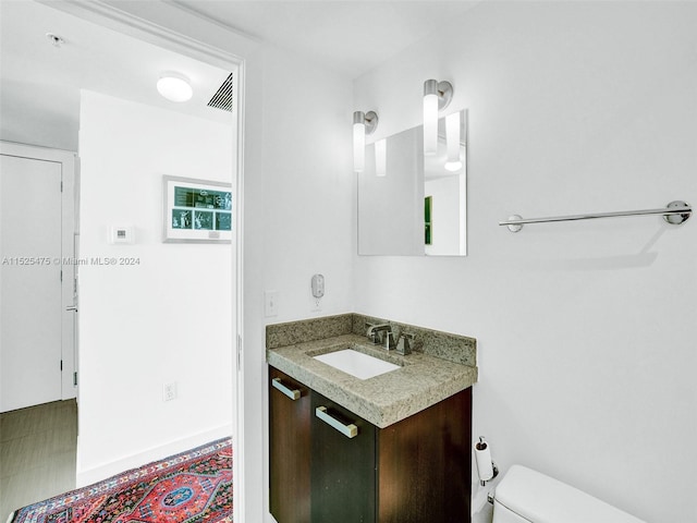 bathroom with vanity and toilet