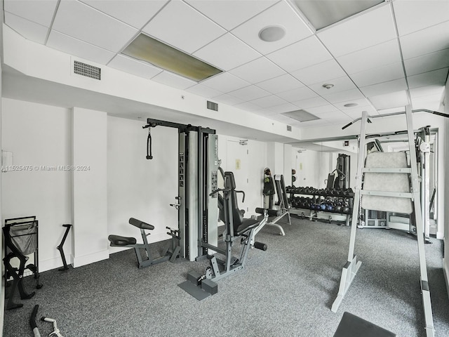 exercise room featuring a paneled ceiling