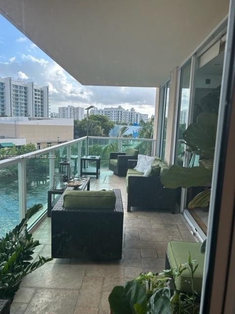 balcony with a water view and outdoor lounge area