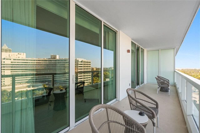 balcony with a view of the beach and a water view