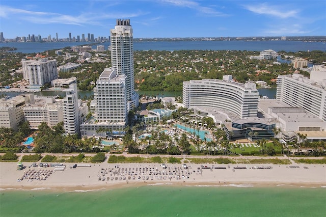 birds eye view of property featuring a water view and a beach view