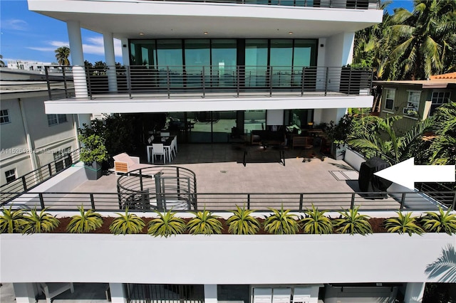 rear view of house with a balcony and a patio area