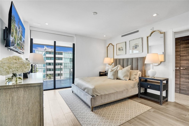 bedroom featuring light hardwood / wood-style floors and access to exterior