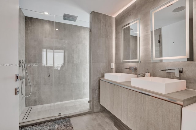 bathroom featuring vanity, tile walls, and an enclosed shower