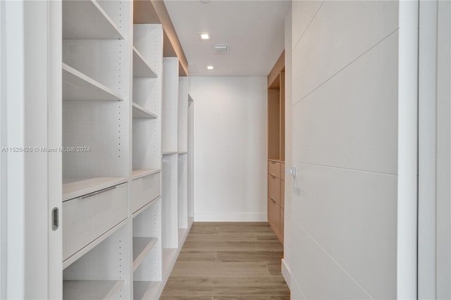 spacious closet featuring light hardwood / wood-style floors