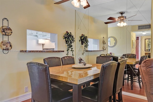 dining space featuring a textured ceiling, ceiling fan, and hardwood / wood-style flooring