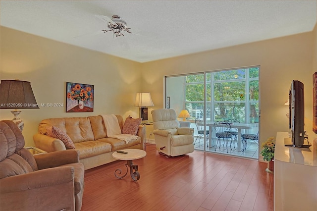 living room with hardwood / wood-style floors and a textured ceiling