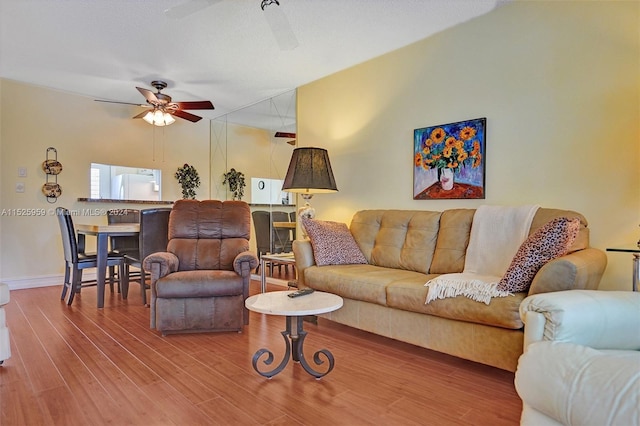 living room with hardwood / wood-style floors and ceiling fan