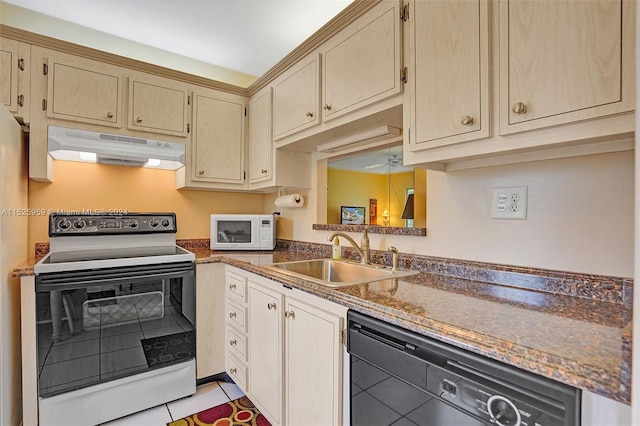 kitchen with stone counters, ceiling fan, white appliances, sink, and light tile floors