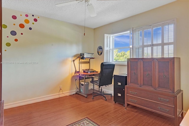 office space with a textured ceiling, wood-type flooring, and ceiling fan