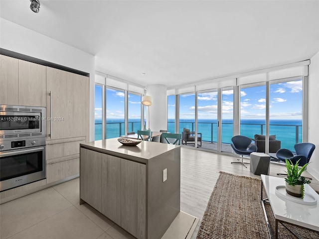 kitchen with a water view, stainless steel appliances, and a kitchen island