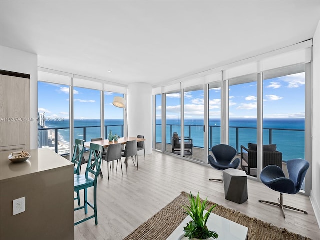 sunroom / solarium featuring a water view