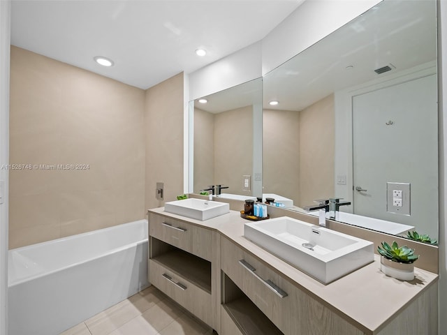 bathroom featuring a tub, tile floors, and dual bowl vanity