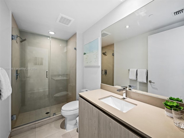 bathroom featuring an enclosed shower, vanity, tile flooring, and toilet